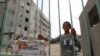 A boy stands at the gate to a section of the National Hospital that was being refurbished by Doctors Without Borders in the northern Syria city of Raqa on Oct. 13, 2018. 