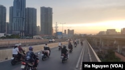 FILE - Vietnam is the fourth biggest market in the world for motorbikes, which millions of drivers like these in Ho Chi Minh City rely on daily.
