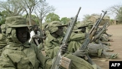 Child soldiers of the Sudan People's Liberation Army wait in a file photograph from 2001.