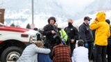 Police guard people evacuated after a call of an active shooter at the King Soopers grocery store in Boulder, Colorado, March 22. 2021. 