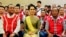 FILE - Myanmar's Foreign Minister Aung San Suu Kyi sits with members of the United Wa State Army (UWSA) following a meeting of armed ethnic groups in Naypyitaw, Myanmar, July 29, 2016.