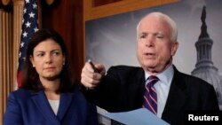 U.S. Republican Senators John McCain (R) and Kelly Ayotte are seen at a news conference on Capitol Hill in Washington, D.C., in this December 21, 2012, file photo.