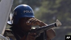 A stone hits the gun of a UN peacekeeper from Nigeria during a protest in Port-au-Prince, Haiti, Thursday, Nov. 18, 2010.