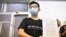 Hong Kong pro-democracy activist Joshua Wong holds up his notice for disqualification at a news conference in Hong Kong on July 31, 2020, a day after he and 11 other activists were barred from standing for election.