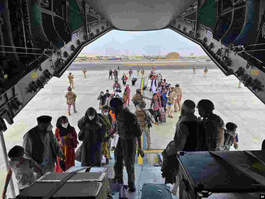 In this image provided by the Spanish Defence Ministry, people board a Spanish air force A400 plane as part of an evacuation plan at Kabul airport in Afghanistan.