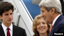 U.S. Ambassador to Japan Caroline Kennedy and her son, Jack Schlossberg, greet Secretary of State John Kerry as he arrives, ahead of G-7 foreign minister meetings, at Marine Corps Air Station Iwakuni, Japan, April 10, 2016.