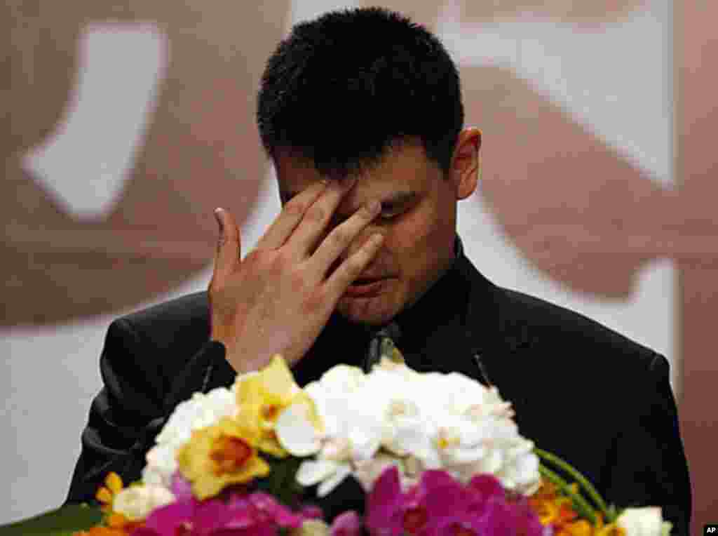 NBA player Yao Ming reacts during a news conference to announce his retirement from basketball in Shanghai, July 20, 2011 (Reuters).