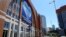 FILE - A cyclist passes past the American Airlines Center, home of the Dallas Mavericks and the Dallas Stars, in Dallas, Texas, April 16, 2020. 