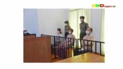 FILE - A screen grab from Myawaddy TV video shows deposed Myanmar leader Aung San Suu Kyi (center-left) and President Win Myint (center) appear before a special court in Naypyitaw, May 24, 2021.