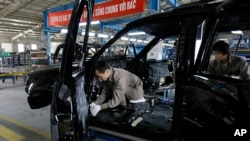 FILE - Workers are seen at the Ford Hai Duong production facility in Hai Duong, Vietnam, 60 kilometers (38 miles) from Hanoi, March 10, 2009. 