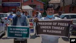 Kashmiri journalists hold placards during a protest against a new media policy that was announced last month in Srinagar, Indian controlled Kashmir, July 6, 2020.