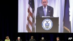 German Chancellor Angela Merkel, bottom left, attends the transmission of a speech of U.S. Commerce Secretary Wilbur Ross, on screen, during a reception of the Economy Council of the German Christian Democratic Party in Berlin, Germany, June 27, 2017.