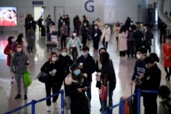 Passengers wearing masks are seen at Pudong International Airport, in Shanghai, China, Jan. 27, 2020.