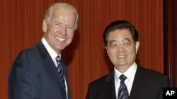 US Vice President Joe Biden (L) shakes hands with Chinese President Hu Jintao before heading to their meeting at the Great Hall of the People in Beijing on August 19, 2011.
