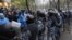 Riot police separate opposition and pro-government activists outside an election precinct in Kiev where the opposition alleged election fraud in Kiev, Ukraine, November 2, 2012.