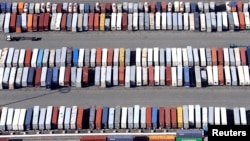 FILE - Shipping containers are stacked up at the ports of Los Angeles and Long Beach, California, Feb. 6, 2015.