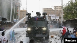 Riot police use water cannon as they clash with opposition supporters during a nationwide protest over cost of living and President William Ruto's government in Eastleigh neighborhood of Nairobi, Kenya, March 20, 2023. 