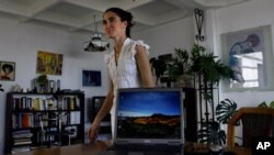 Yoanis Sanchez, who writes the "Generation Y" blog, walks inside her home in Havana, Friday, April 11, 2008. 