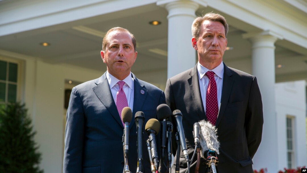Health and Human Services Secretary Alex Azar, left, and acting FDA Commissioner Ned Sharpless speak with reporters after a meeting about vaping with President Donald Trump in the Oval Office of the White House, Sept. 11, 2019, in Washington. 
