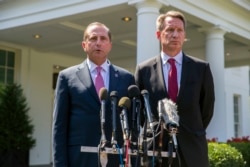 Health and Human Services Secretary Alex Azar, left, and acting FDA Commissioner Ned Sharpless speak with reporters after a meeting about vaping with President Donald Trump in the Oval Office of the White House, Sept. 11, 2019, in Washington.
