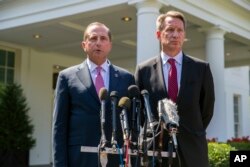 Health and Human Services Secretary Alex Azar, left, and acting FDA Commissioner Ned Sharpless speak with reporters after a meeting about vaping with President Donald Trump at the White House, Sept. 11, 2019, in Washington.