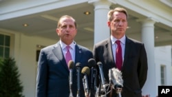 Health and Human Services Secretary Alex Azar, left, and acting FDA Commissioner Ned Sharpless speak with reporters after a meeting about vaping with President Donald Trump in the Oval Office of the White House, Sept. 11, 2019, in Washington. 