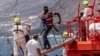 FILE - Migrants disembark at the port in Valverde at the Canary island of El Hierro, Spain, on Aug. 26, 2024, after they arrived by boat from a 13-day voyage from the coast of Senegal.