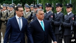 Hungary's Prime Minister Viktor Orban is greeted by his Polish counterpart Mateusz Morawiecki at the start of his one-day visit, at the Lazienki Palace in Warsaw, Poland, May 14, 2018.