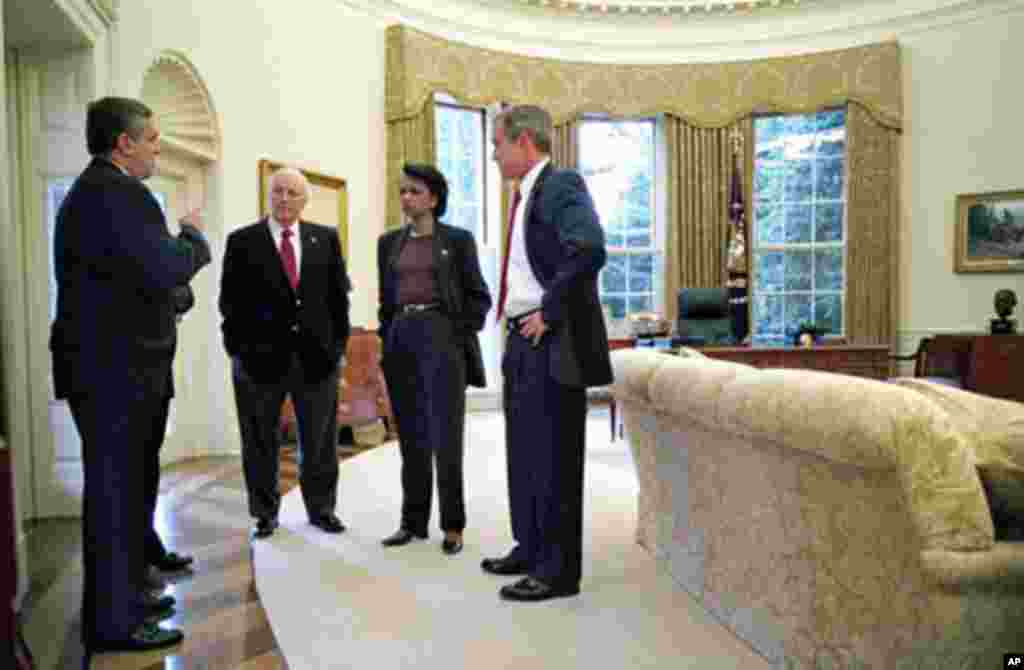 In this October 7, 2001 file photo, President George W. Bush, right, meets with CIA Director George Tenet, Vice President Dick Cheney and National Security Adviser Condoleezza Rice in the Oval Office after the president informed the nation that air strike