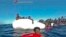 This frame of a video taken by the Italian Coast Guard on Jan. 6, 2018, in the Mediterranean Sea off Libya, shows migrants being rescued from dinghies as they try to cross to Italy.