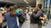 In this photo released by Department of Migrant Workers, freed Filipino crew members, who were among those taken hostage aboard the Galaxy Leader in Yemen, are welcomed by family as they arrive at Manila's International Airport on Jan. 23, 2025. 