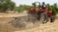 A farmer plows the field in Saulawa village, on the outskirts of Nigeria's north-central state of Kaduna, May 2013 file photo. 