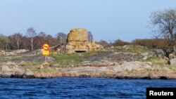 FILE - A mock road-traffic sign prohibiting submarines is seen April 29, 2015, marking the site where a Russian Whiskey-class submarine ran aground near the Swedish naval port of Karlskrona in 1981.