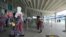 A family is seen in a line at the domestic wing of the Nnamdi Azikiwe International Airport on its reopening day for domestic flight operations, following the coronavirus disease outbreak, in Abuja, Nigeria, July 8, 2020.
