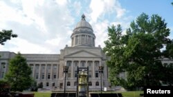 A caged statue of Confederate President Jefferson Davis departs on a truck after being removed from the state capitol in Frankfort, Kentucky, June 13, 2020.