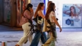 Women carrying rifles walk on Dizengoff Square, amid the ongoing conflict between Israel and Hamas in Gaza and the hostilities between Hezbollah and Israeli forces, in Tel Aviv, Israel, Oct. 28, 2024. 