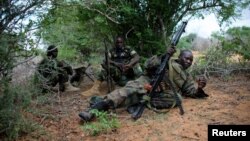 A soldier serving with the African Union Mission in Somalia takes up a defensive position in a fire fight during their joint AMISOM and Somali National Army (SNA) operation to seize and liberate territory from al-Shabab militants in Deyniile, Somalia, May