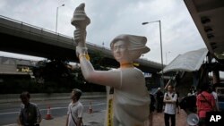 A statue of the Goddess of Democracy is displayed during a pro-democracy protest near the China Liaison Offices in Hong Kong Sunday, May 31, 2015. 