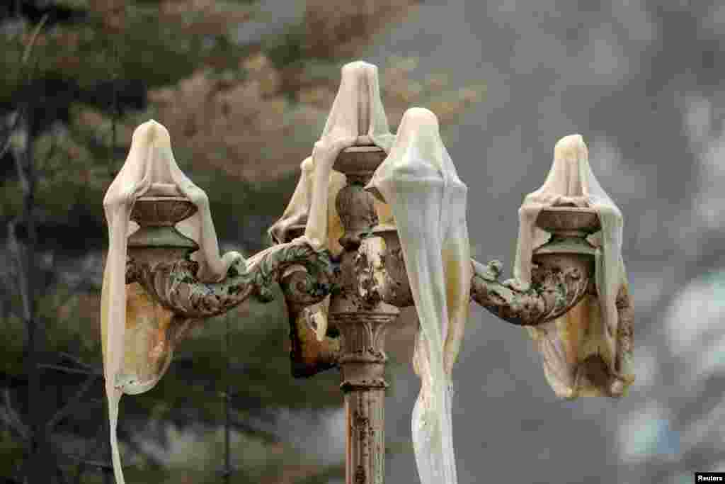 Melted outdoor lighting is seen after the Dixie Fire torn through the Greenville community of Plumas County, California, Aug. 10, 2021.