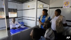 Claude Mabowa Sasi, 21, who had lost his mother, a brother and a sister to Ebola, takes his college-entry exam in an isolation room at an Ebola treatment center in Beni, Congo, July 20, 2019. 