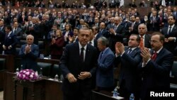 Turkey's Prime Minister Tayyip Erdogan leaves his seat to address members of parliament from his ruling AK Party (AKP) during a meeting at the parliament in Ankara, April 8, 2014.