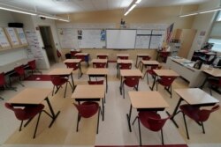 FILE - A classroom sits empty ahead of the statewide school closures in Ohio in an effort to curb the spread of the coronavirus, inside Milton-Union Exempted Village School District in West Milton, Ohio, March 13, 2020.