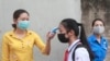 A student is scanned for temperature before entering Dinh Cong secondary school in Hanoi, Vietnam Monday, May 4, 2020.