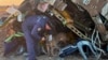 In this photo released by Kazakhstan's Emergency Ministry Press Service, a rescuer search at the wreckage of Azerbaijan Airlines' Embraer 190 laying on the ground near the airport of Aktau, Kazakhstan, Dec. 26, 2024.