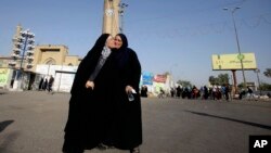 Iraqi Muslims exchange greetings after the Eid dawn prayers outside the Abu Hanifa mosque on the first day of the Eid al-Fitr holiday in the Azamiyah area of north Baghdad, Iraq, Aug. 8, 2013.