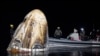 This photo provided by NASA shows support teams working around the SpaceX Dragon Endeavour spacecraft shortly after it landed in the Gulf of Mexico off the coast of Pensacola, Florida, Oct. 25, 2024. (NASA/Joel Kowsky via AP)