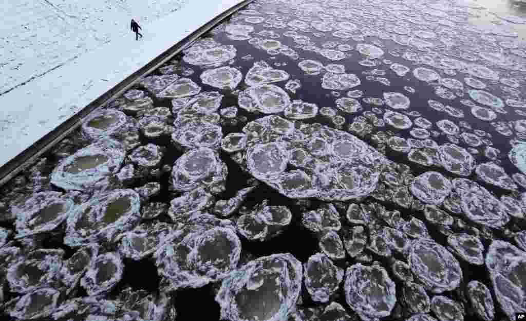 A pedestrian walks along the banks of the Neris River as temperatures dipped to -18&deg;C (-4&deg;F) in Vilnius, Lithuania. 