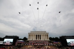 President Donald Trump, first lady Melania Trump, Vice President Mike Pence and Karen Pence and others stand as the US Army Band performs and the US Navy Blue Angels flyover at the end of an Independence Day celebration in front of the Lincoln Memorial, J