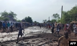 Residents run after hearing an explosion near the local government headquarters in Gedaref, Sudan, on July 11, 2024.