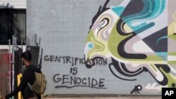 Graffiti marks a wall across the street from a Metro PCS store, May 25, 2019 in the Shaw neighborhood of Washington. 